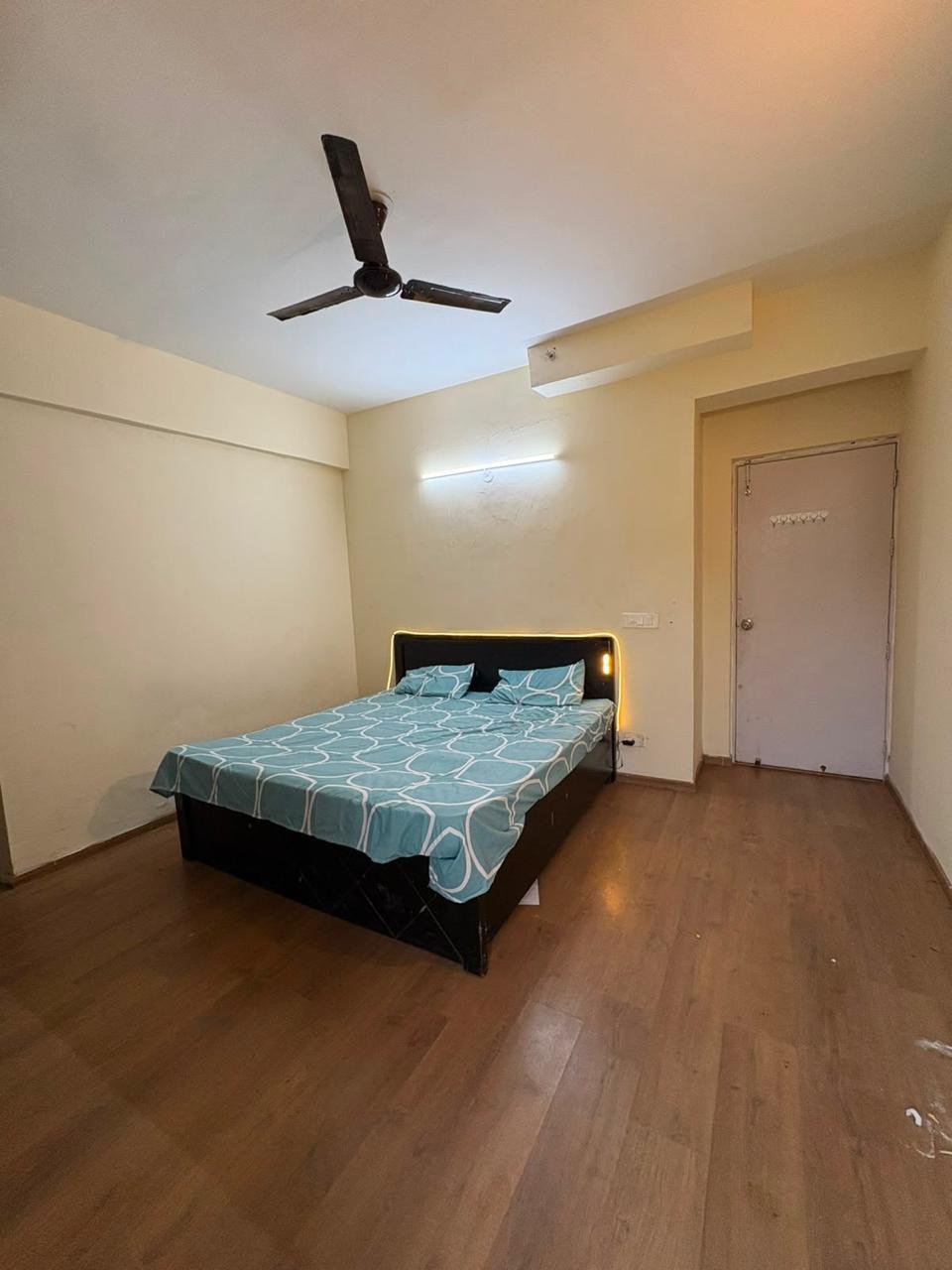 Spacious bedroom with ambient backlight headboard