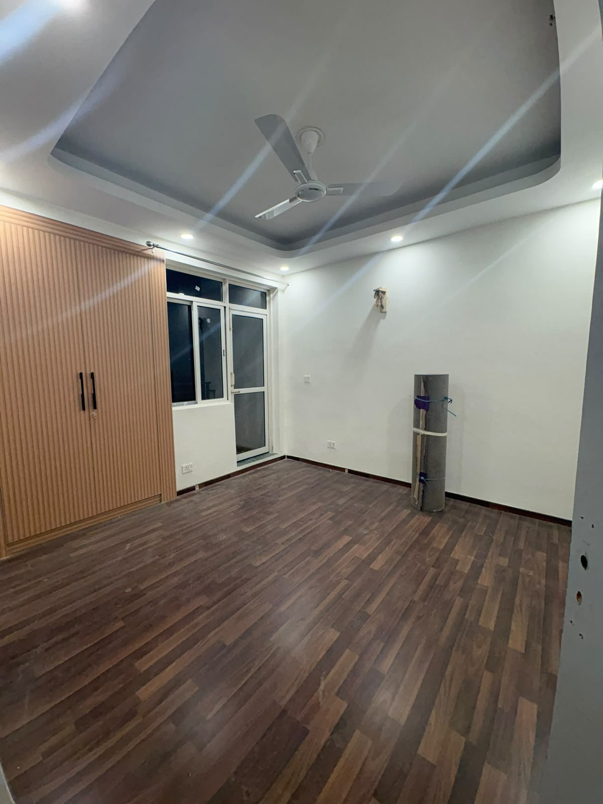 Renovated vacant room with fluted wardrobe