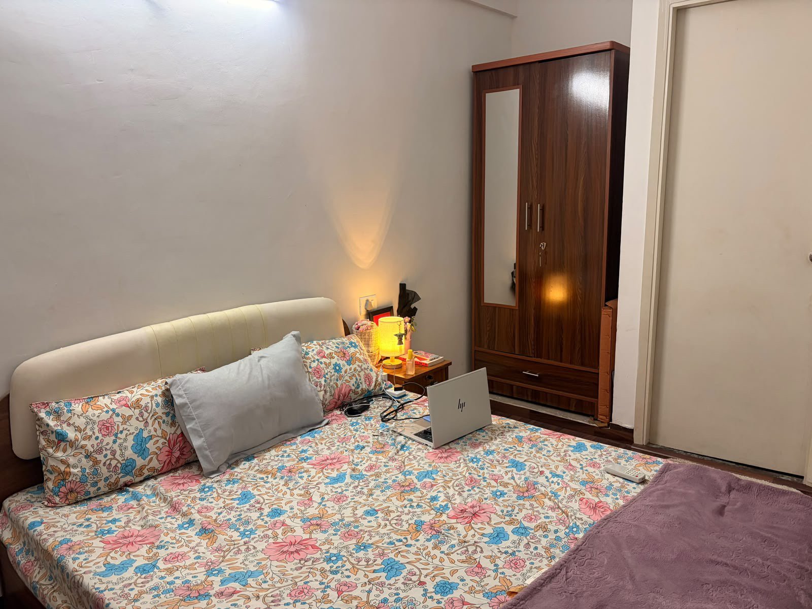 Furnished bedroom with hardwood wardrobe and bedside lighting