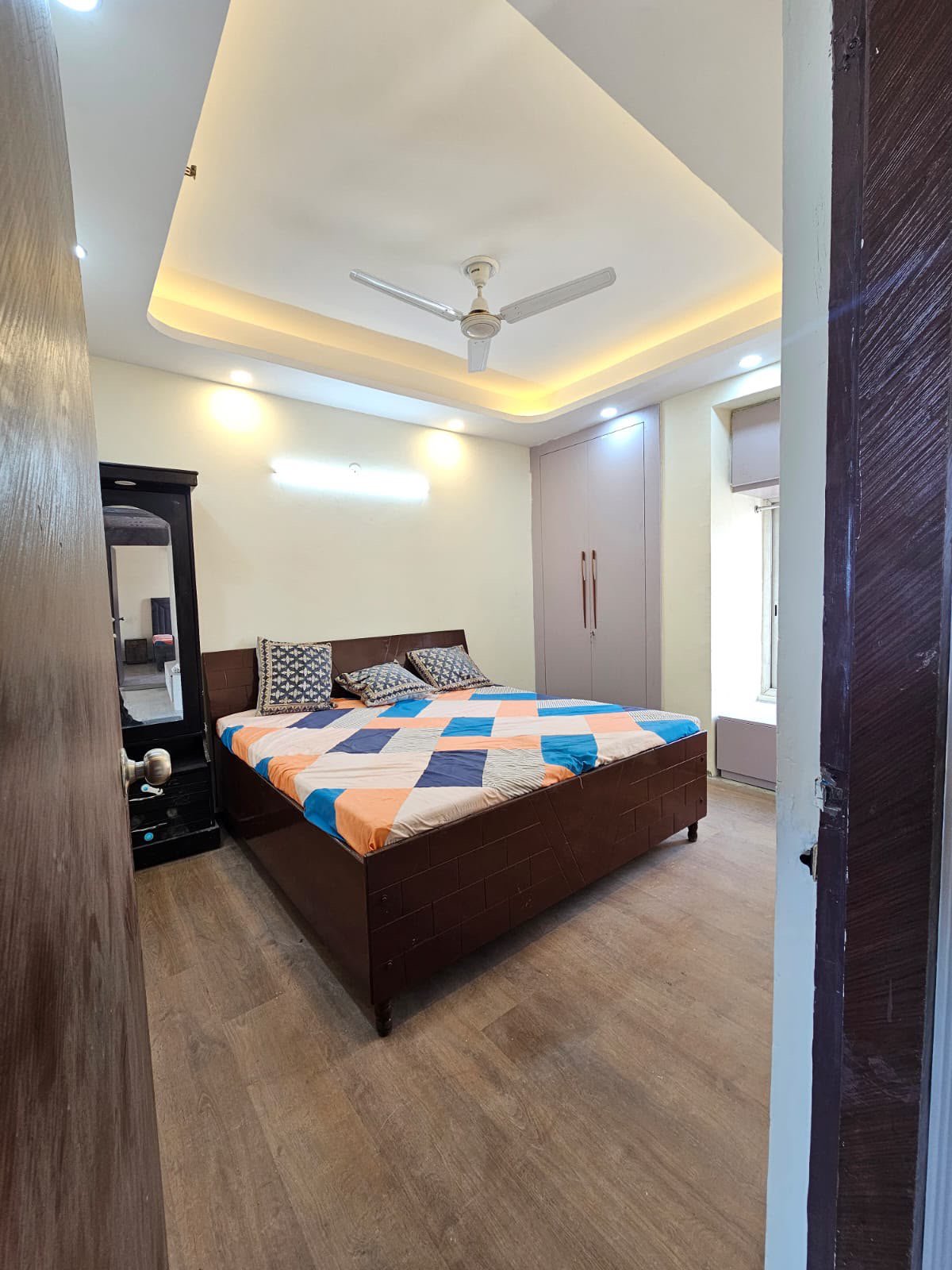 Master bedroom with dressing mirror and wardrobe