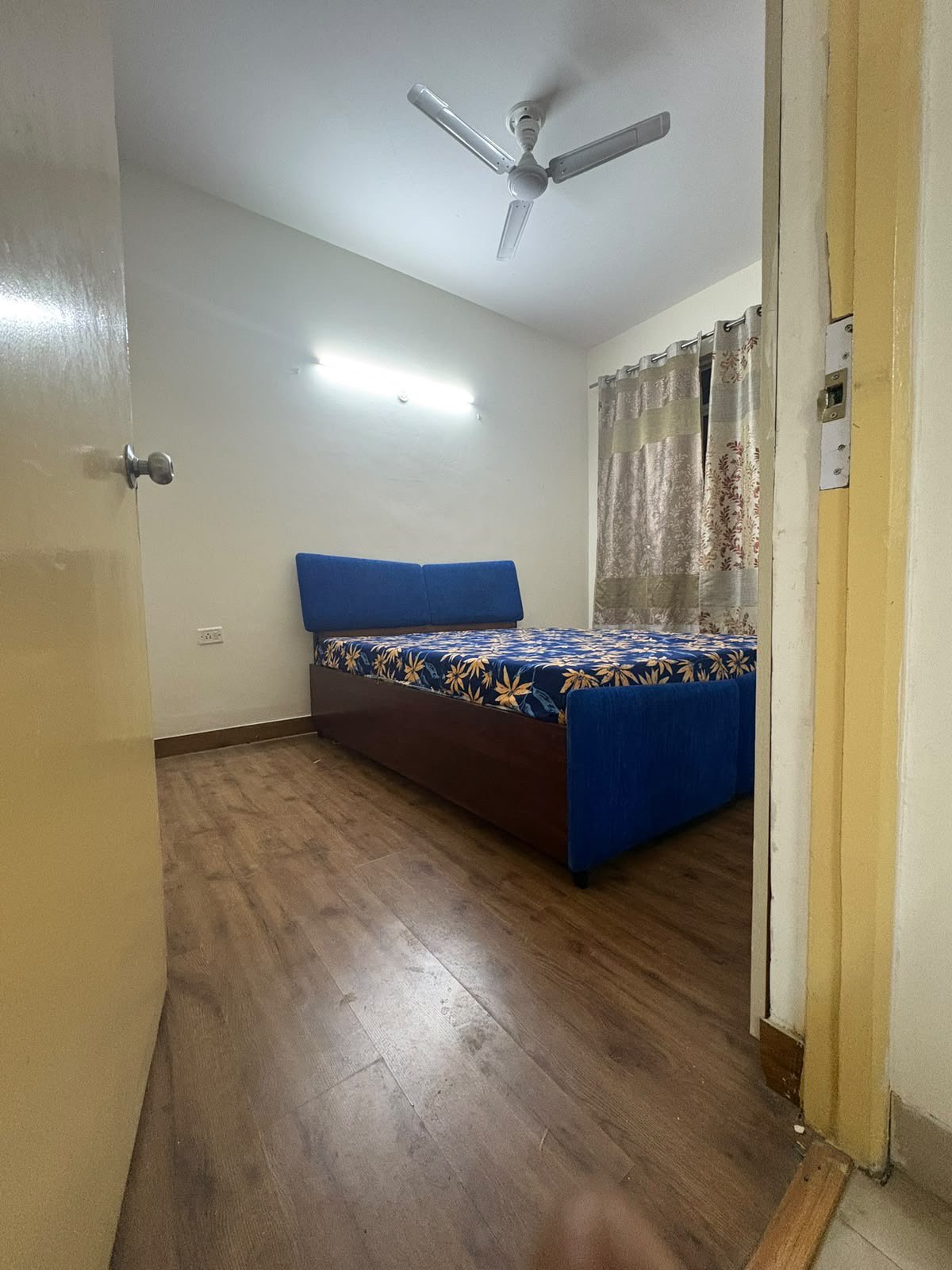 Furnished bedroom with blue headboard bed