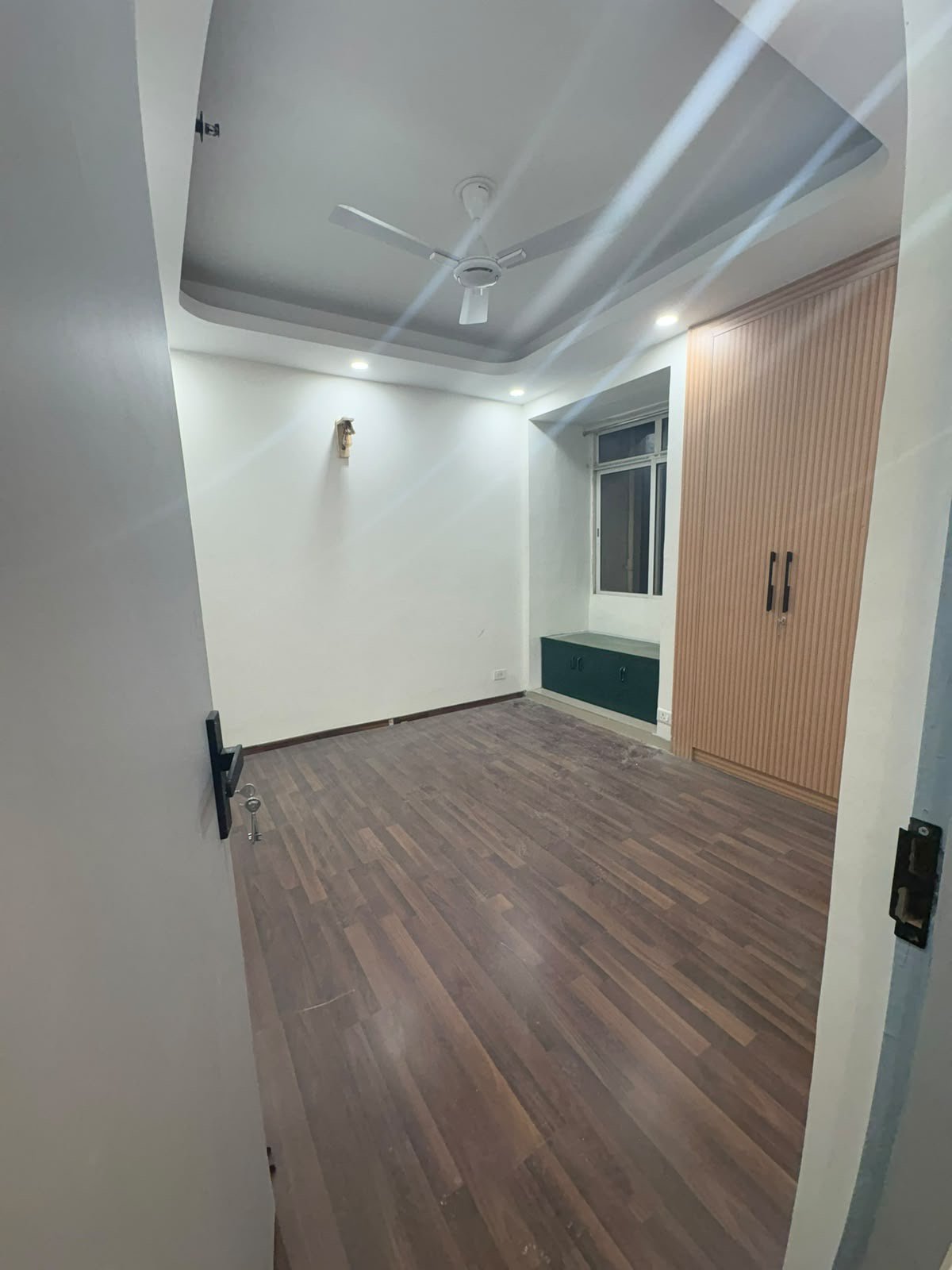 Renovated bedroom with fluted wardrobe and bay window seat