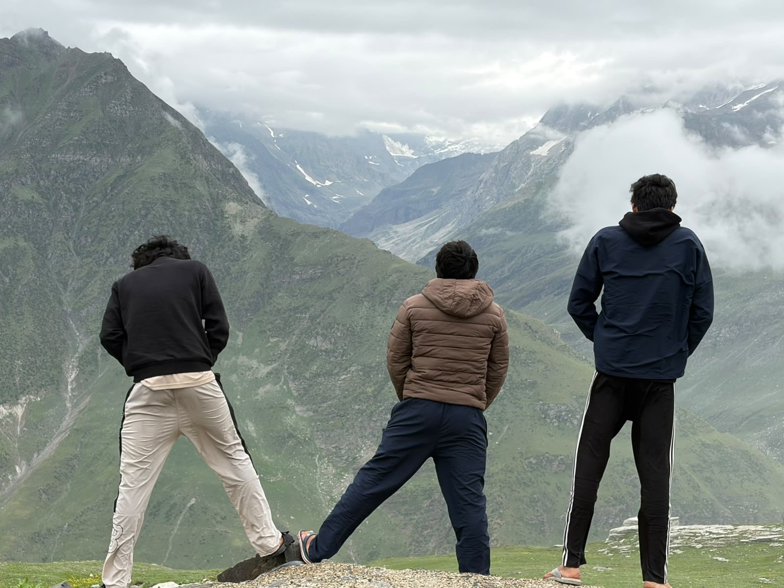 Team members smiling against scenic mountain backdrop