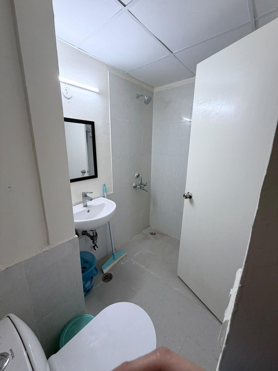 Clean tiled bathroom with shower and fixtures