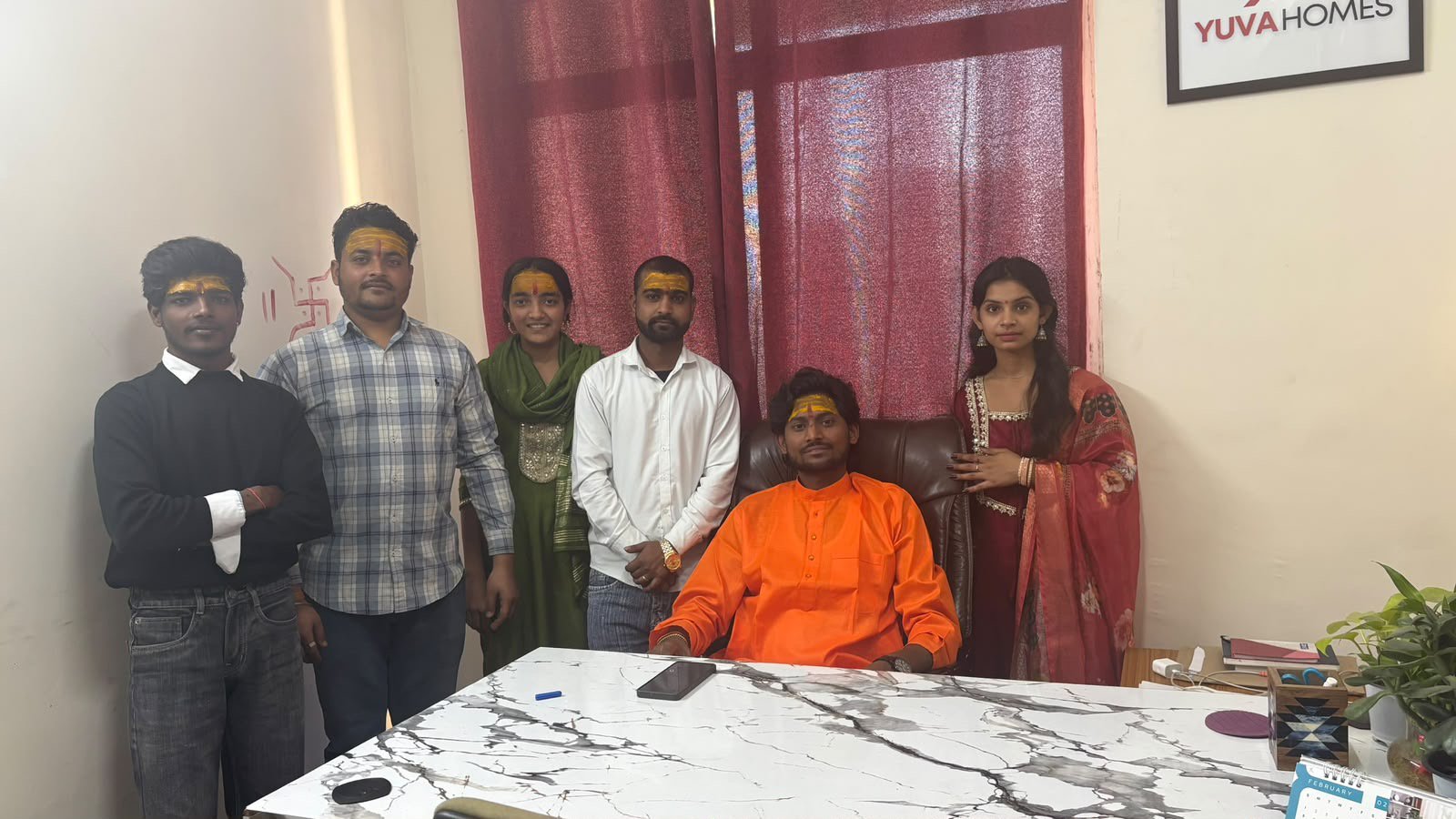Operations team at Yuva Homes desk under company logo
